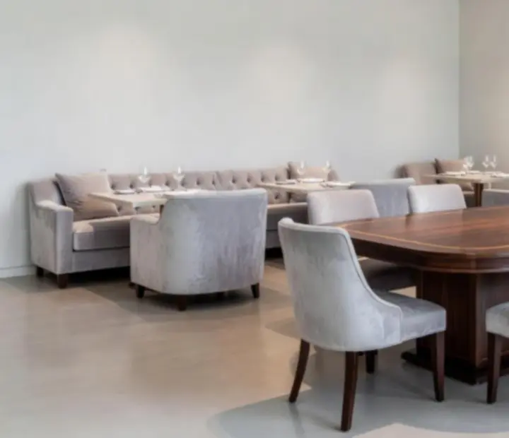 Interior of The Showdown Salon featuring premium timber, luxe banquettes, and a central events table.
